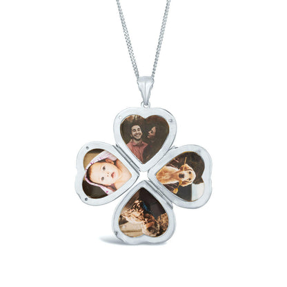 opened silver four photo heart locket on a white background