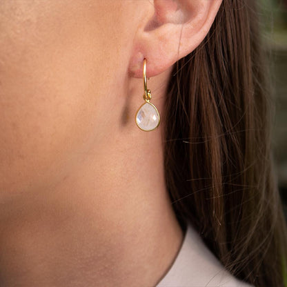 moonstone drop hoop earrings in gold on a white background