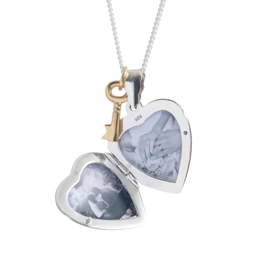 opened key locket in white gold with gold key charm attached on a white background
