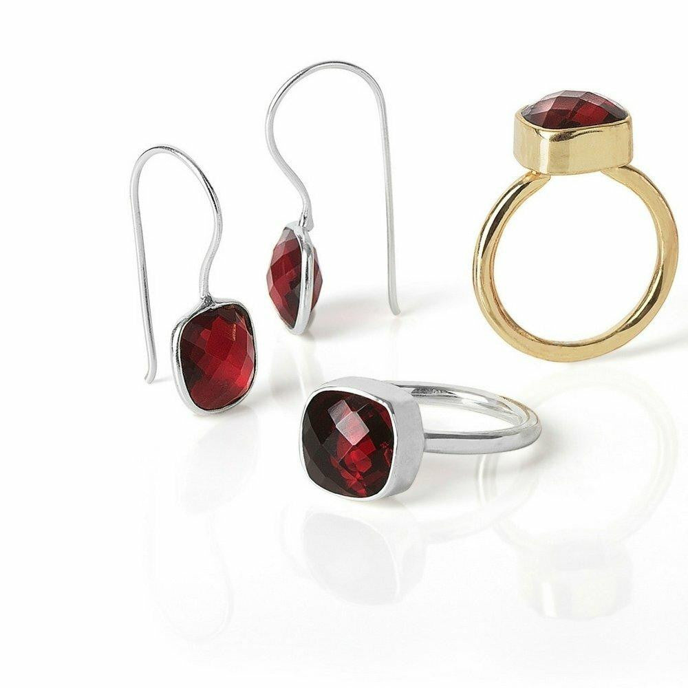 garnet earrings and cocktail rings on a white background