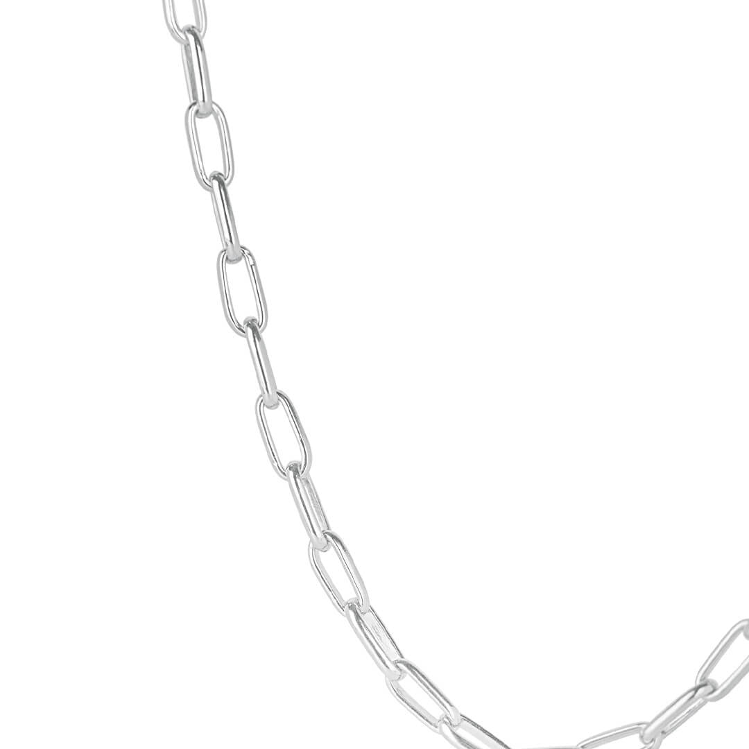 close up of model wearing men's paperclip chain necklace in silver on a white background 