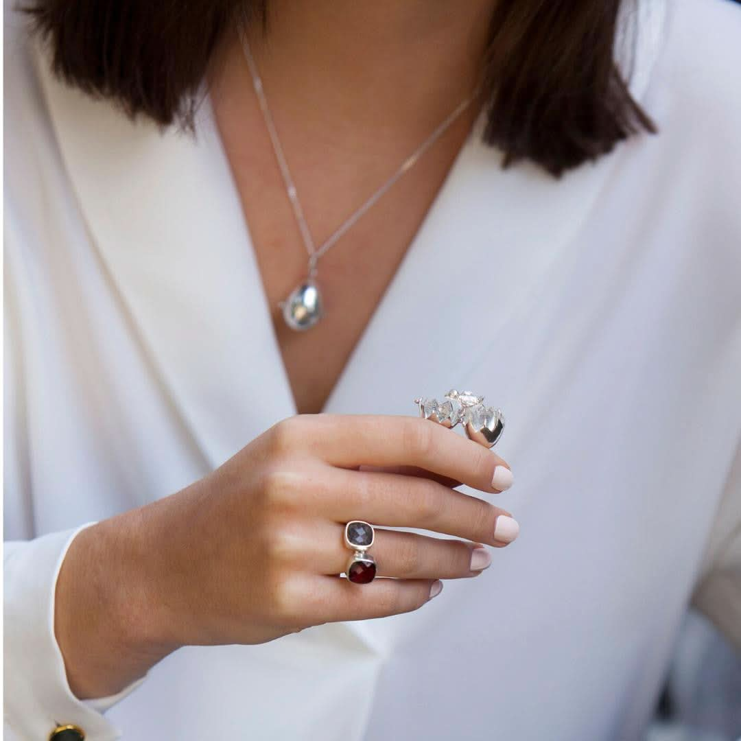 model holding opened charming chick locket in silver 