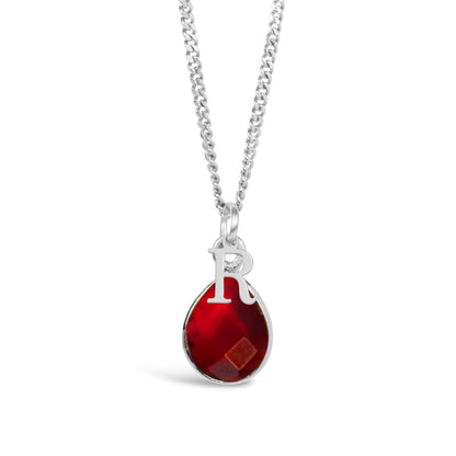 garnet charm necklace in silver with initial charm on a white background