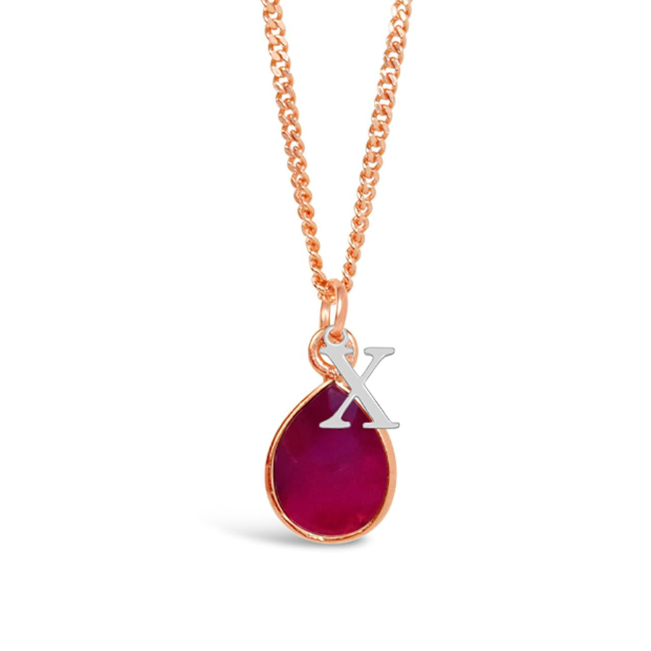 ruby charm necklace in rose gold with silver initial charm on a white background
