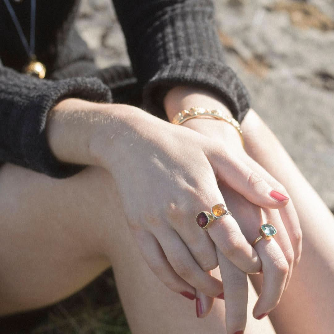 model wearing three cocktail rings in silver