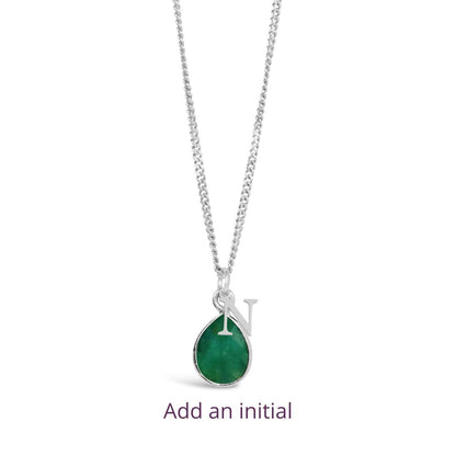 emerald charm necklace in silver with initial charm on a white background