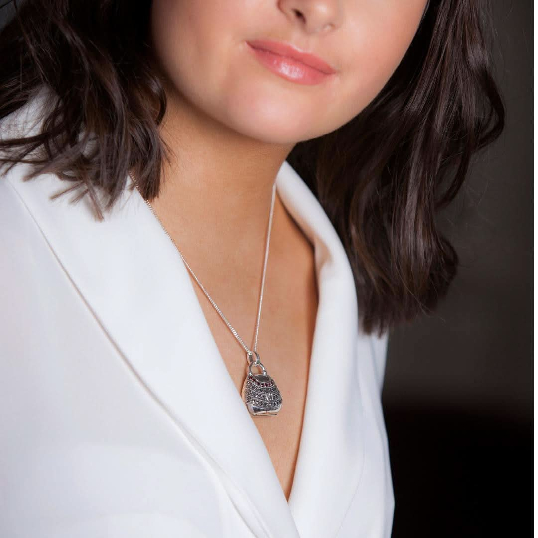 model wearing garnet handbag locket in silver