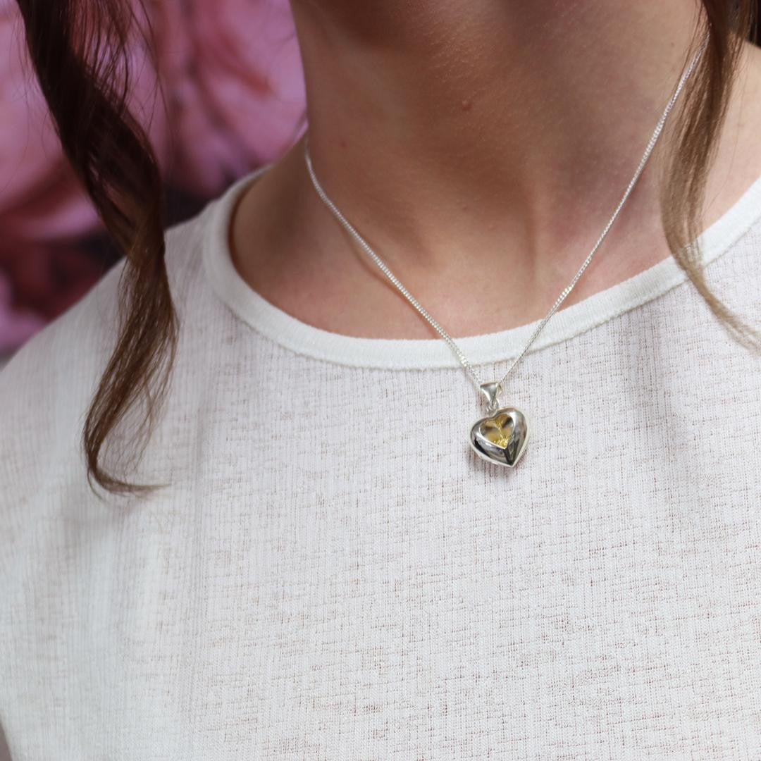 close up of model wearing song in my heart locket in gold