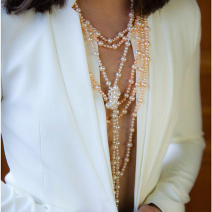 model wearing eternal pearl necklace in champagne
