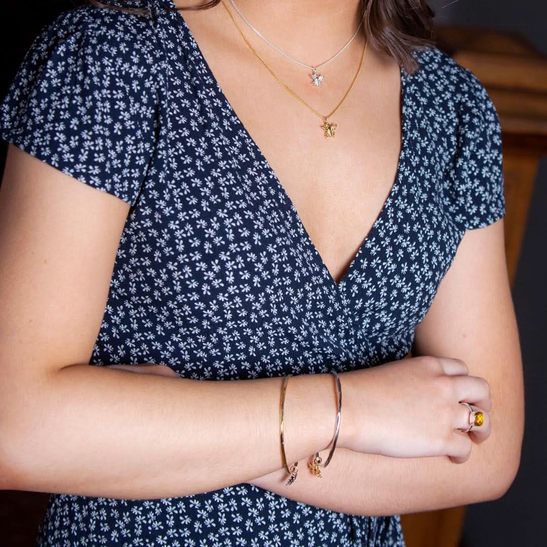 model wearing gold bee bangle