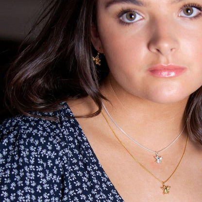 closeup of model wearing bee earrings