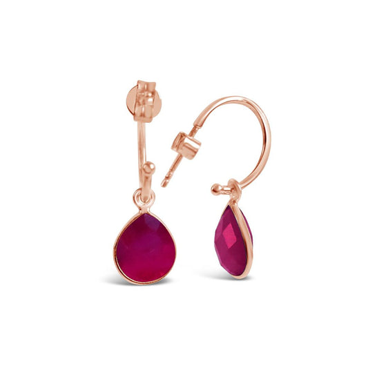 ruby drop hoop earrings in rose gold on a white background