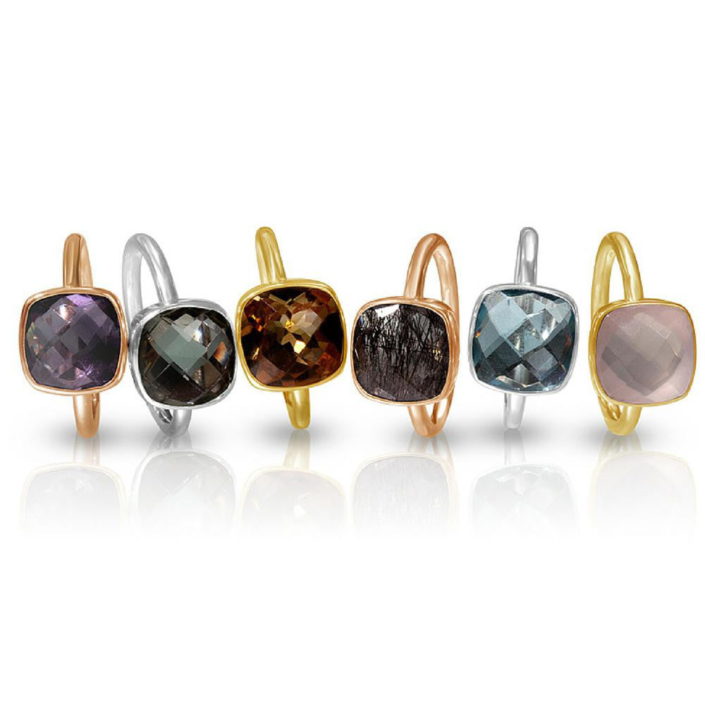 collection of cocktail rings with different gemstones on a white background