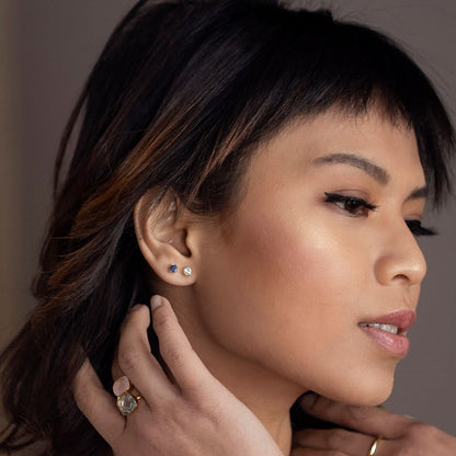 Model wearing sapphire mini stud gemstone earrings