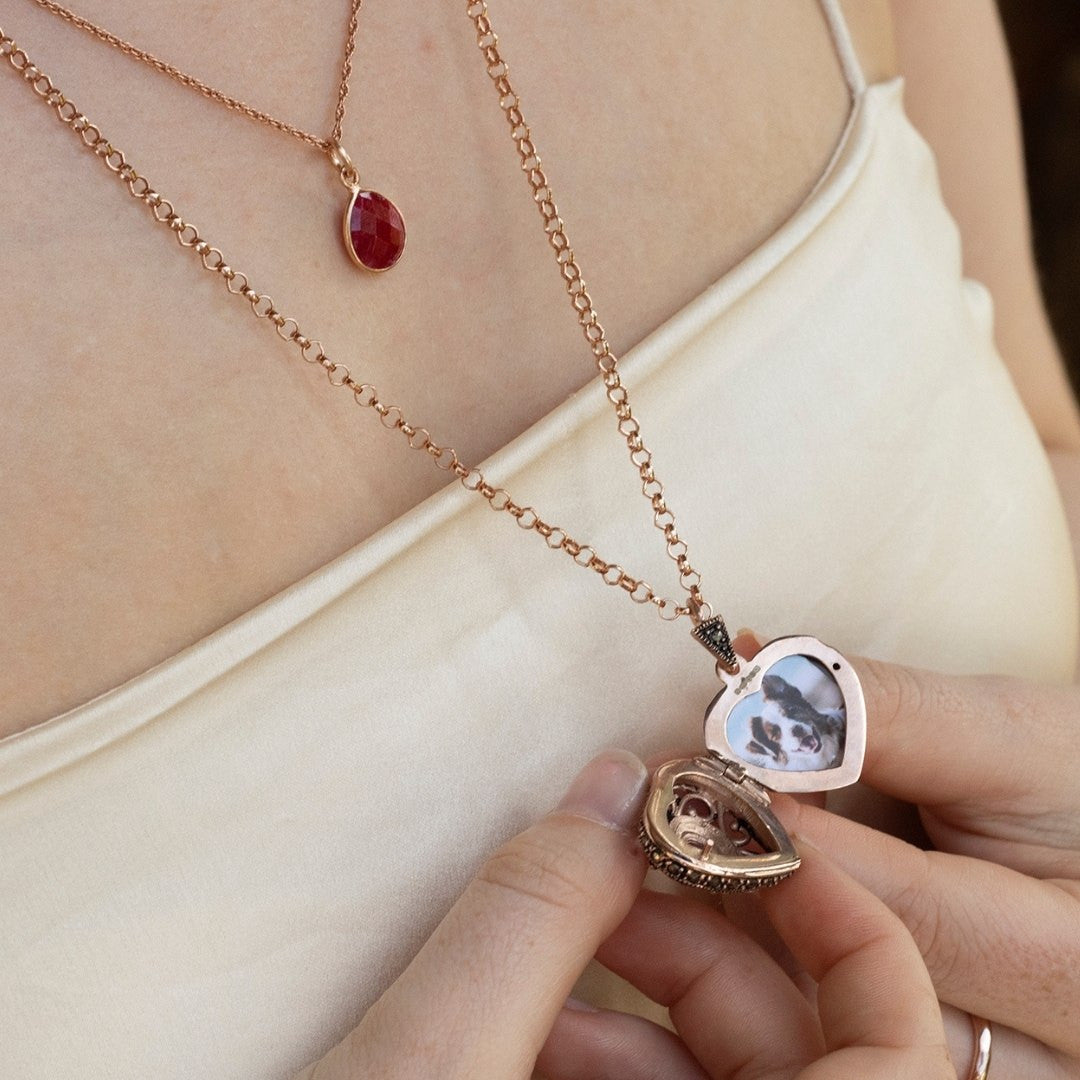 model wearing ruby vintage heart locket in rose gold with photos inside