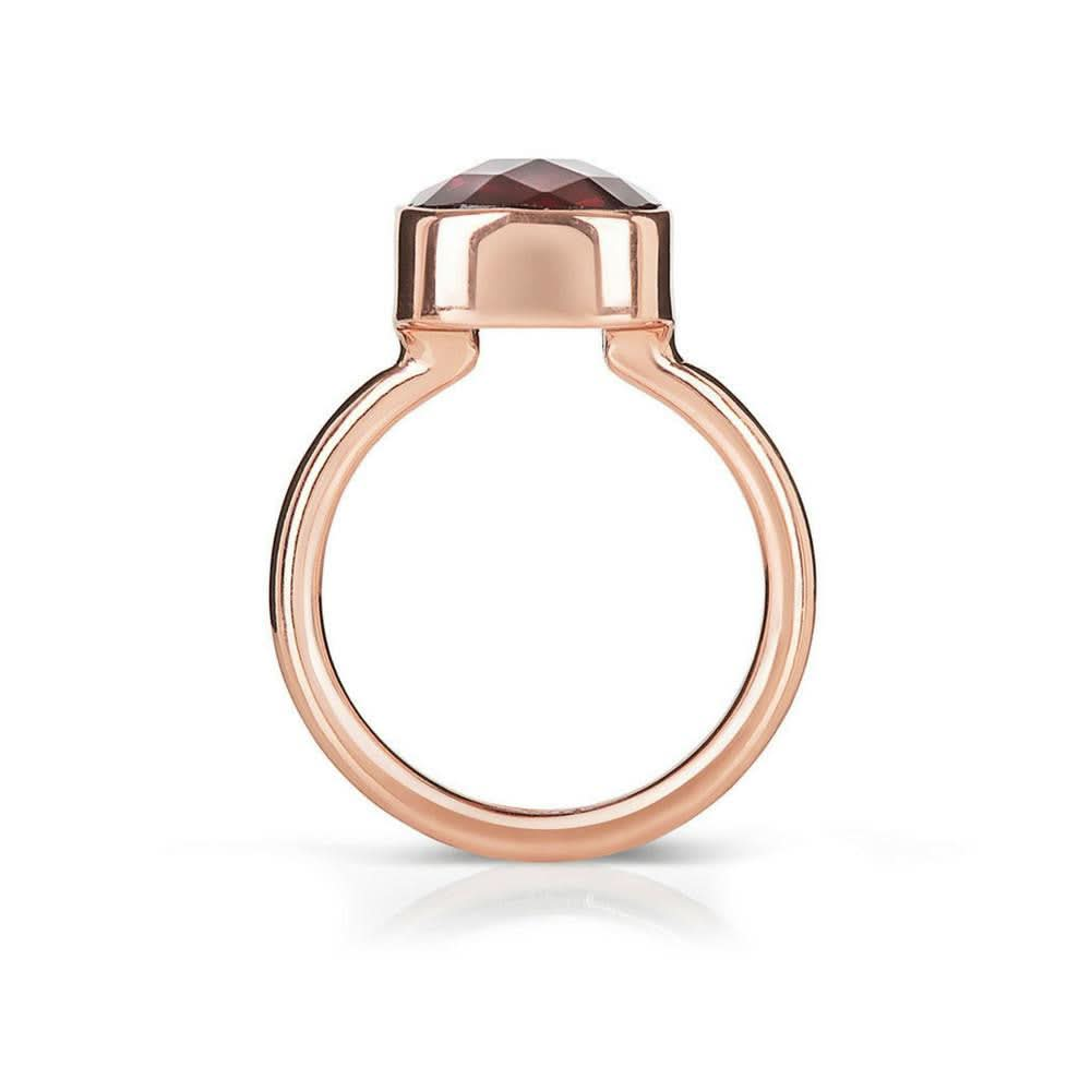 garnet cocktail ring in rose gold on a white background 